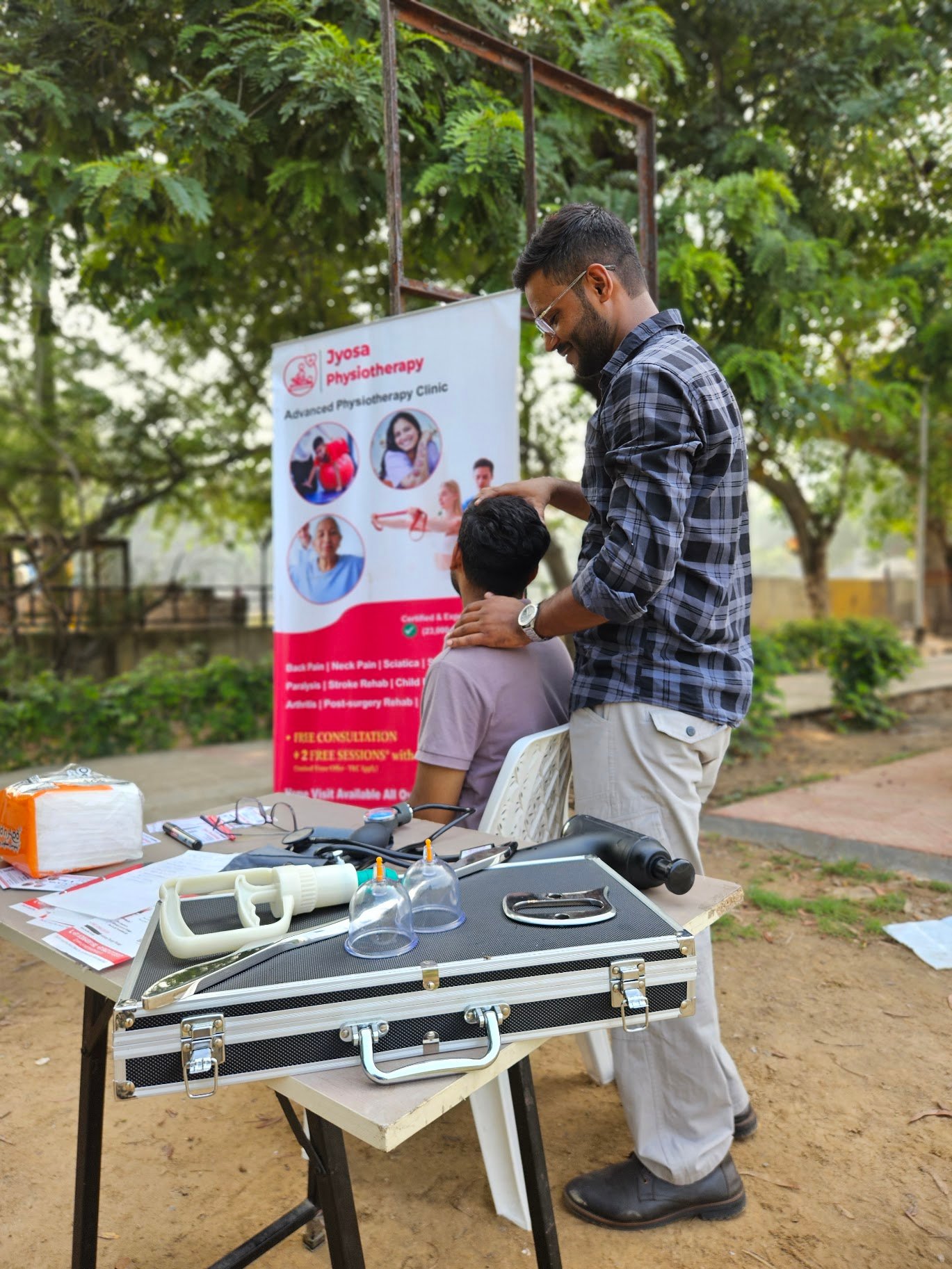 Dr. Avnish Jha PT assisting a patient with neck physiotherapy exercises